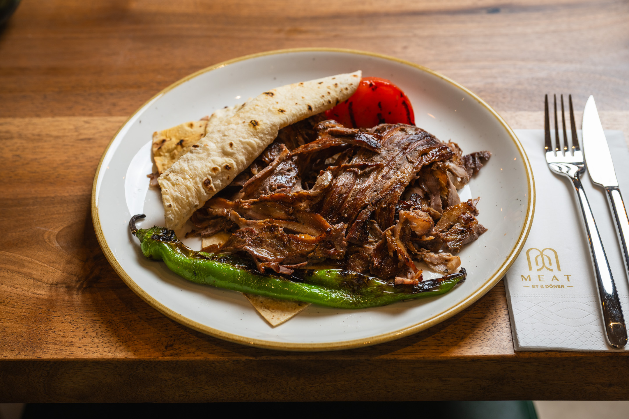 Artisanal Plated Yaprak Döner on Oak Wood Table